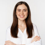 Marta Woźniak close up of confident corporate woman, professional entrepreneur smiling, cross arms on chest and smiling enthusiastic, standing over white background
